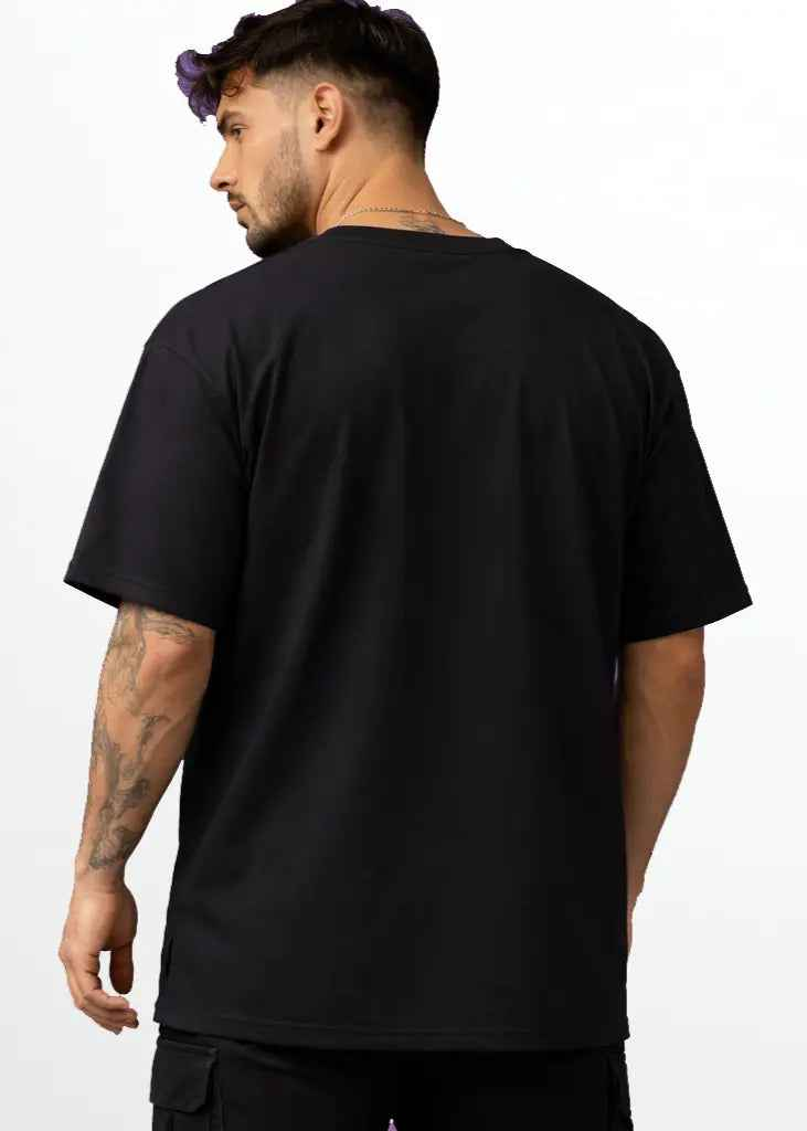 A young man wearing black oversized tshirt back view