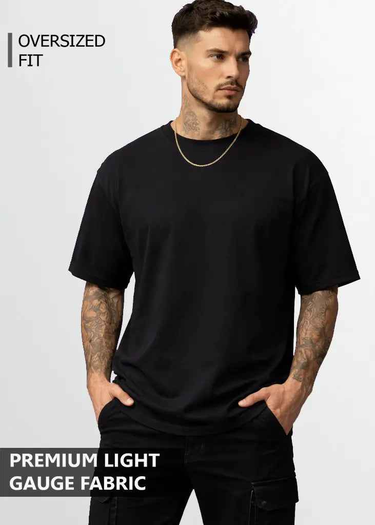 A young man wearing black oversized tshirt front view
