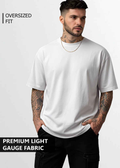 A young man wearing white oversized tshirt front view