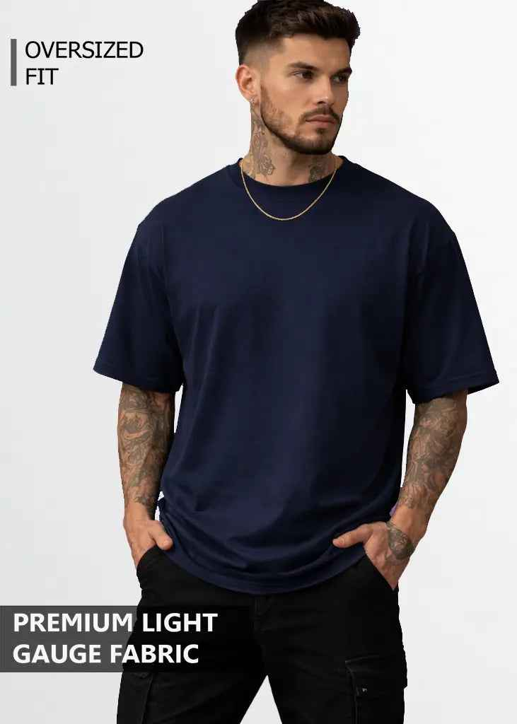 A young man wearing navy blue oversized tshirt front view
